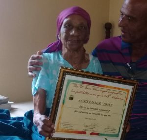 On her 109th birthday, holding the plaque she received at the age of 100. (Source: Facebook)