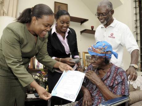 Aged 113, receiving a copy of her birth certificate. (Source: Gladstone Taylor/Jamaica Gleaner)