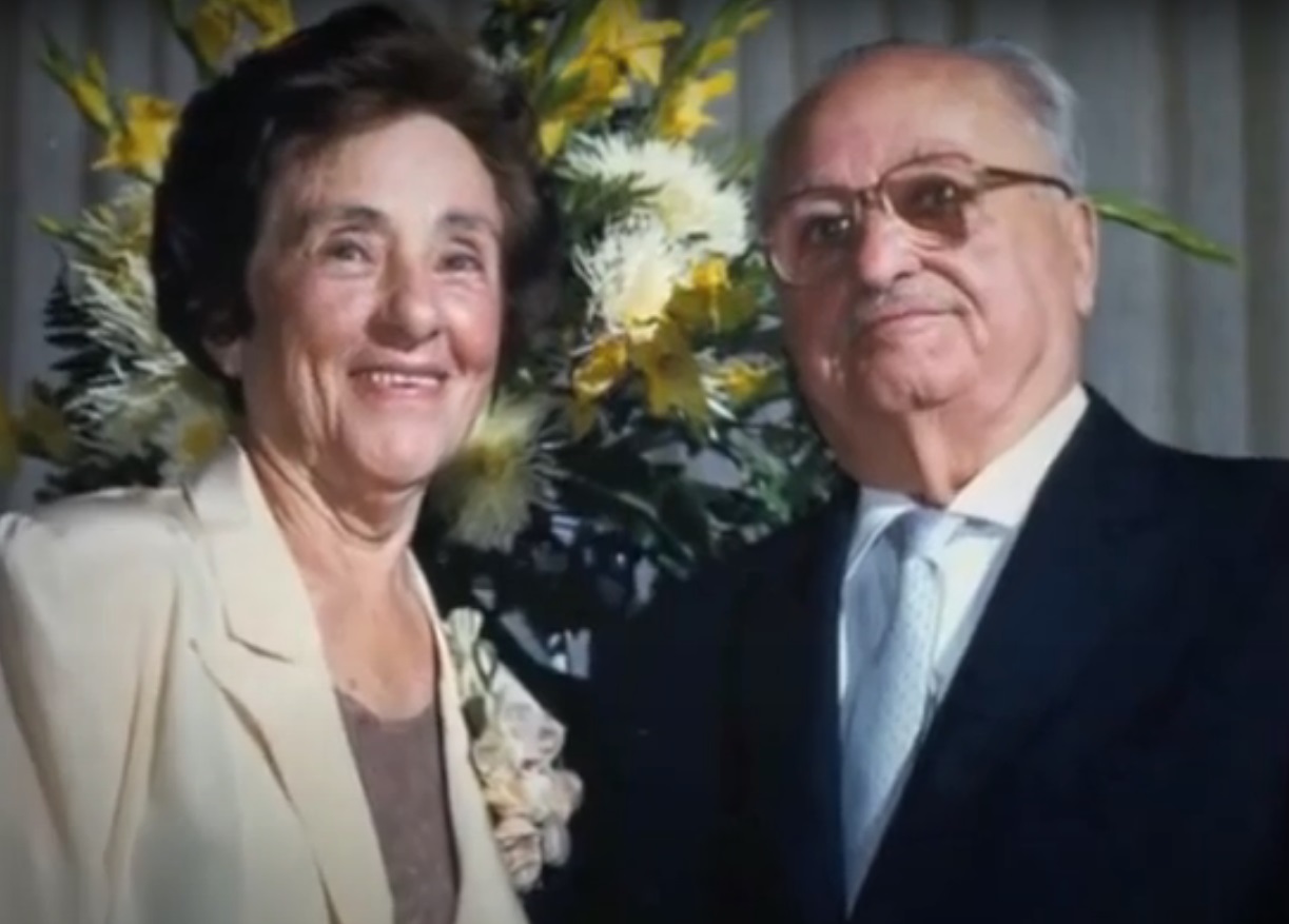 As an elderly woman, with her husband. (Source: YouTube/CADDAH STUDIO)