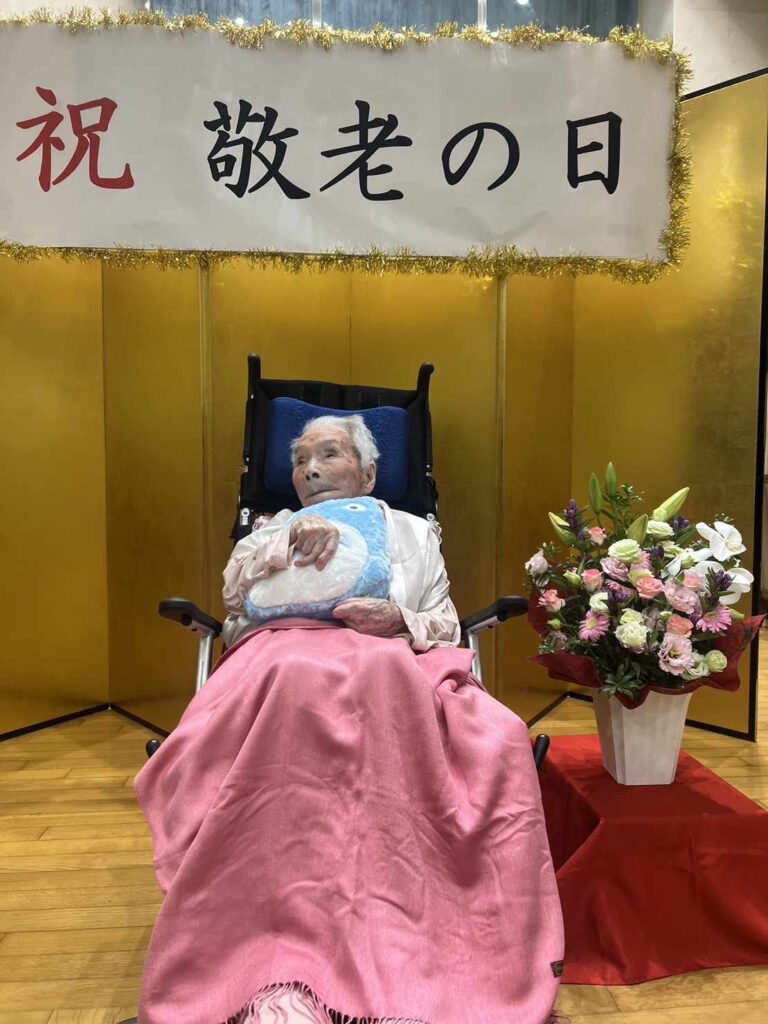 Mrs. Fusa Tatsumi, the country's oldest living resident, pictured with flowers sent by LongeviQuest.