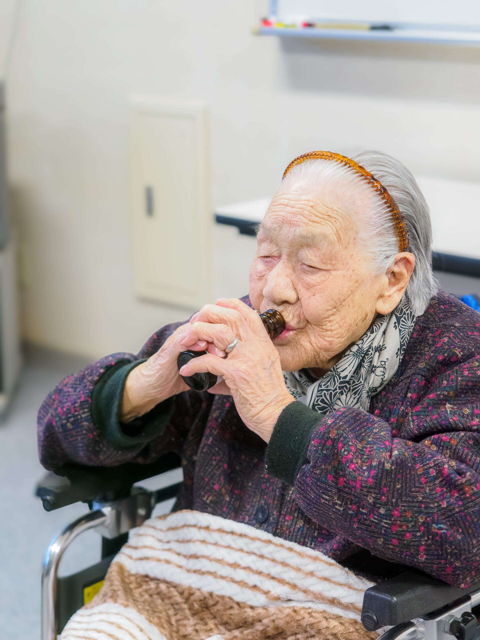 In November 2023, aged 110, drinking her favorite energy drink. (Source: Courtesy of the nursing home)