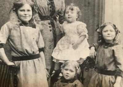 Crosby (sitting front) with her mother and siblings, 1910s. (Source: The Courier Mail)