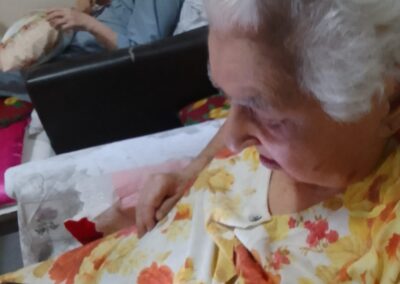 At age 115 on 18 March 2026, enjoying music on a smartphone.