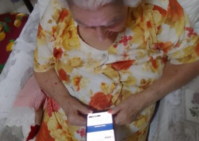 At age 115 on 18 March 2026, enjoying music on a smartphone.