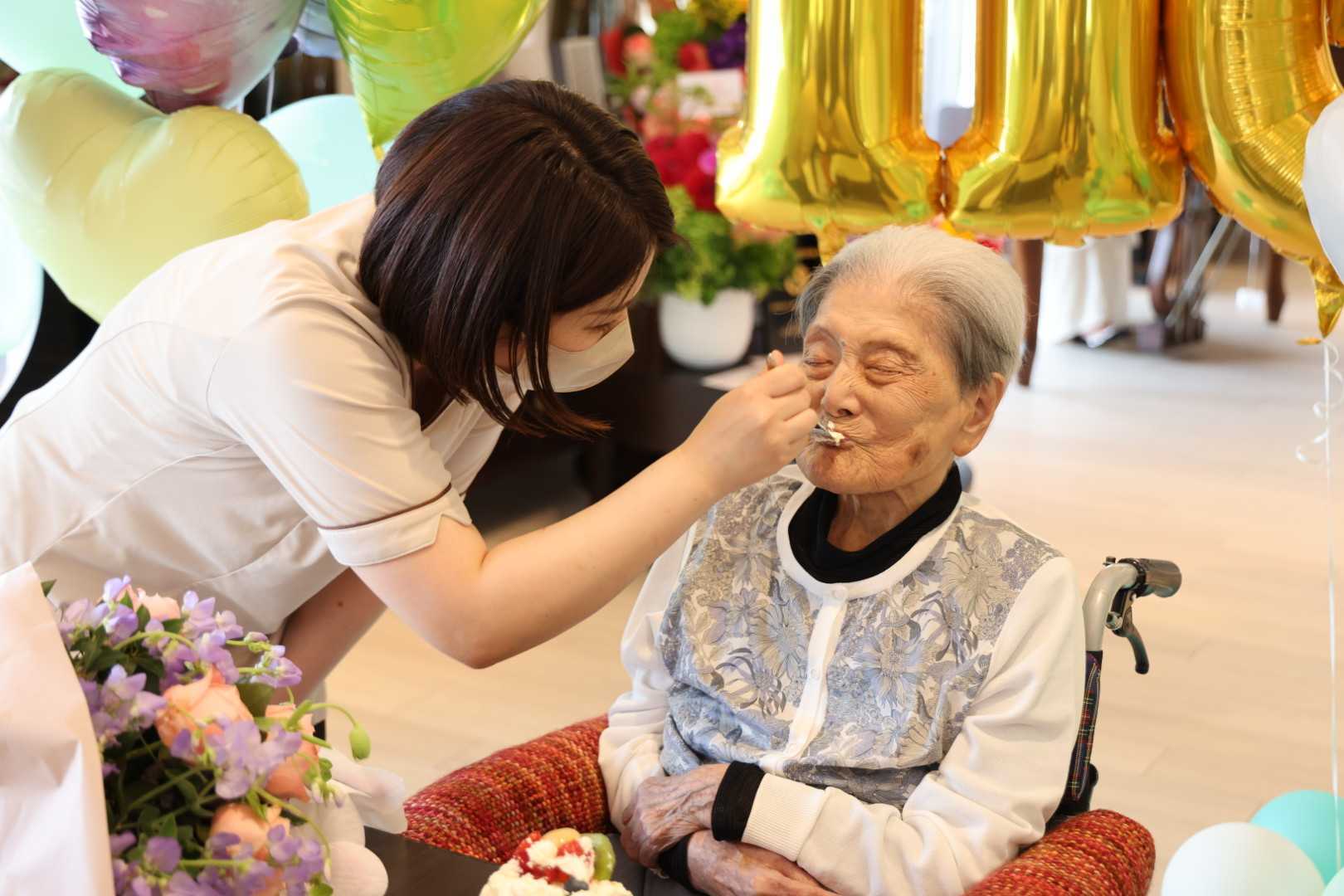 Tomiko Itooka enjoying some of her 116th birthday cake. Photo by LongeviQuest.