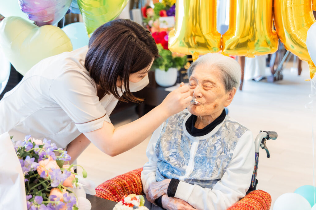 Tomiko Itooka enjoying some of her 116th birthday cake. Photo by LongeviQuest.