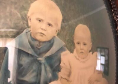 Pictured with his younger sister, Mary, (1913-1997) in 1915. (Source: The 110 Club)