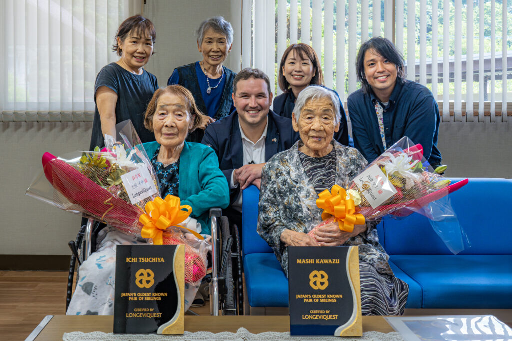 Ichi Tsuchiya and Mashi Kawazu, Japan's oldest known sisters, with their caregivers and LongeviQuest representatives Ben Meyers and Yumi Yamamoto