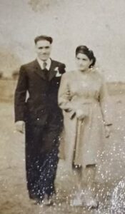 With her husband.
