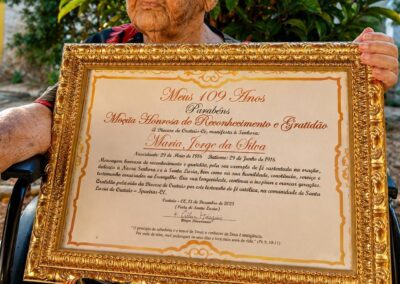 At the age of 110, holding her religious plaque. (28 June 2026)