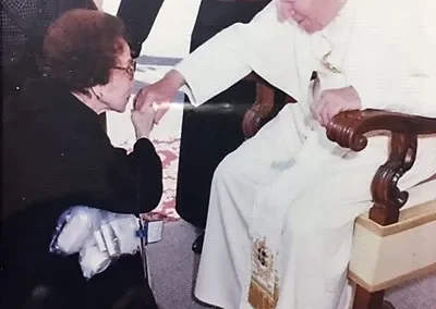 Papa (front left, age 84) kisses St. Pope John Paul II’s hand in 1998. (Source: San Gabriel Valley Tribune)