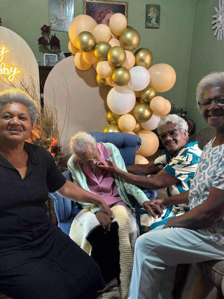 Maria Paschoalina de Castro on her claimed 114th birthday in April 2025, with her daughters.