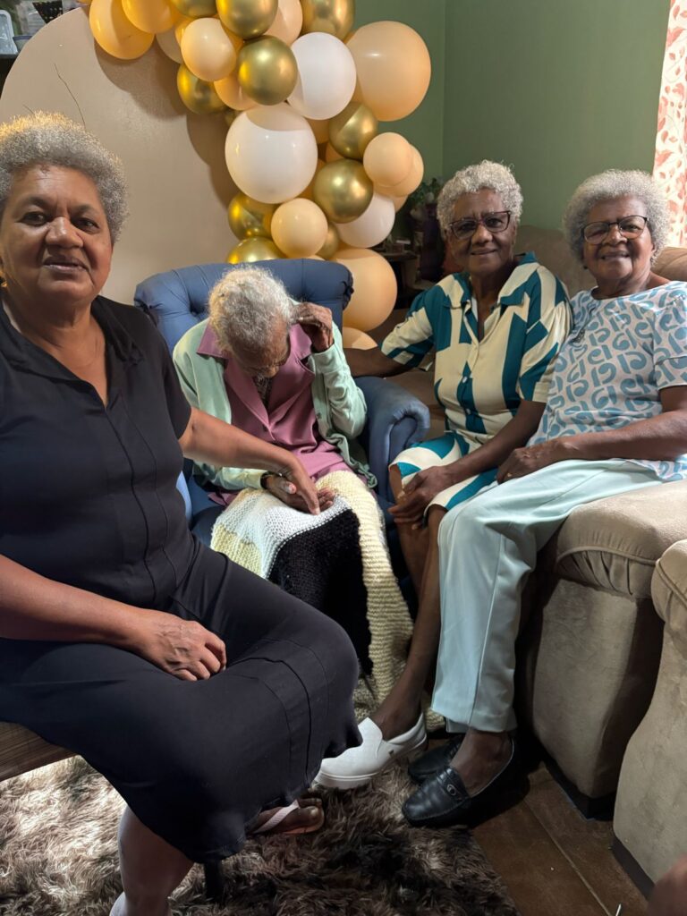 Maria Paschoalina de Castro on her claimed 114th birthday in April 2025, with her daughters.