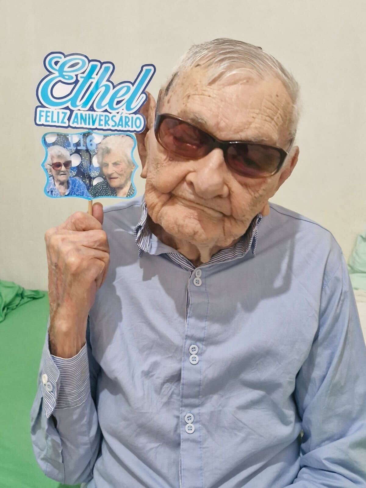 João Marinho Neto, world's oldest man, holding birthday greeting for Ethel Caterham, world's oldest person. Courtesy of the Marinho family.