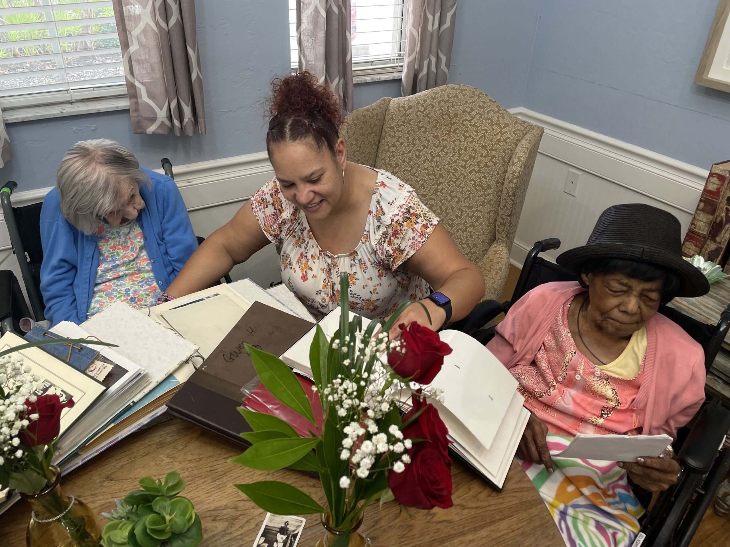 Ms. Veronica and Ms. Gwen going through old memories, guided by Amanda Flores.