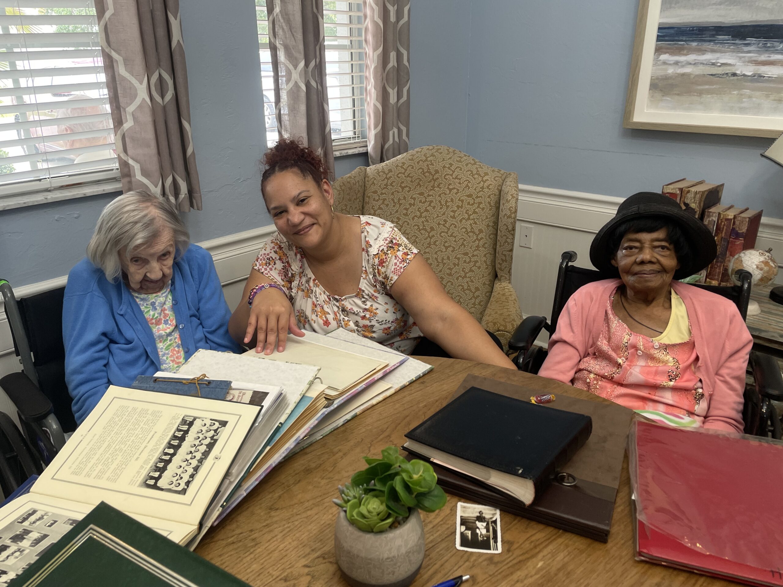 Veronica Pheney and Gwen Hutchinson on either side of their caregiver, Amanda Flores.