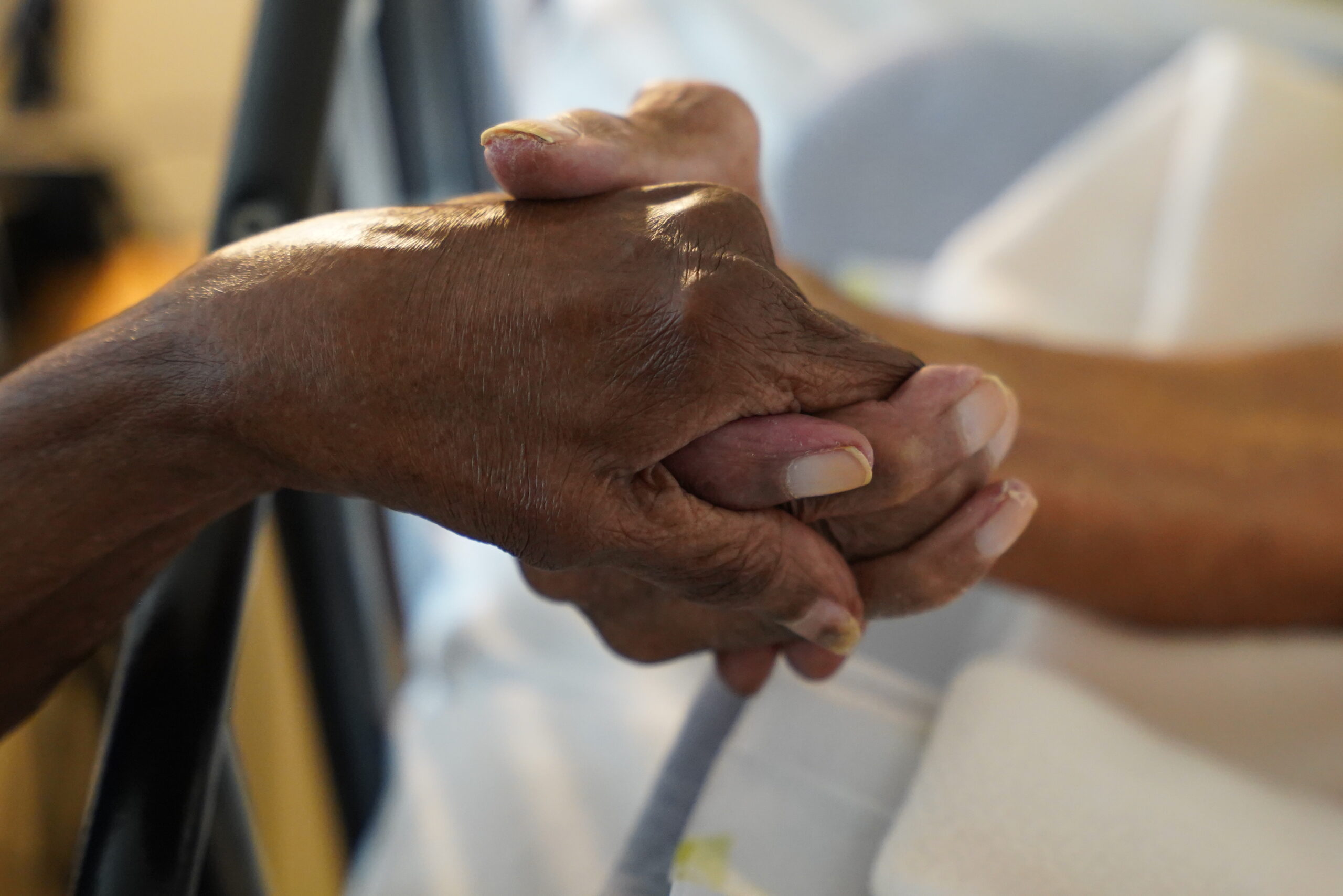 Eleanor and Lyle Gittens, world's longest-married couple, holding hands.