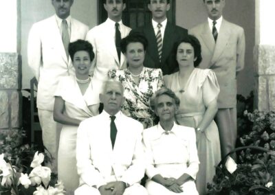 Standing far left in the middle row, with her parents and siblings.