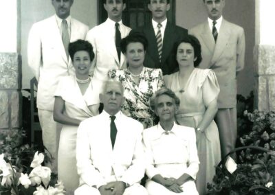 Standing, 1st from the left in the middle row. (With her parents and siblings).
