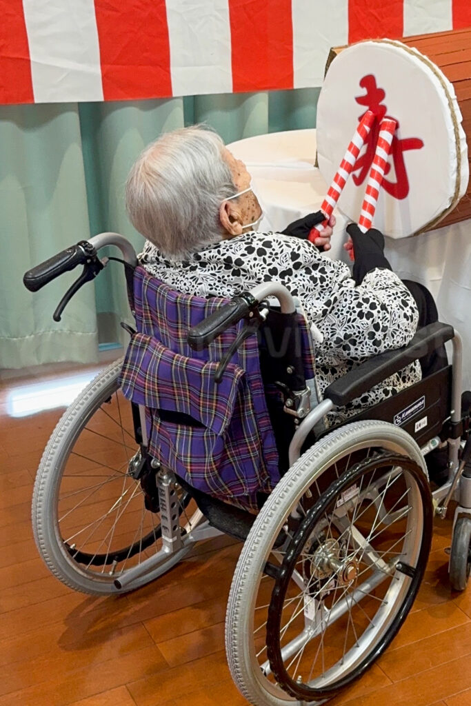 Yoshiko Takasu plays a taiko drum during a Respect for the Aged Day celebration in September 2025, when she was 111 years old. Courtesy of her family.