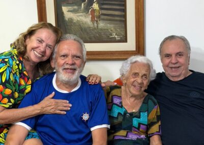 In 2026, at age 107, with her children Angelina, Fernando, and Eulélio. (Salvador, Bahia)