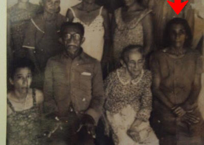 Seated, far right (below arrow).