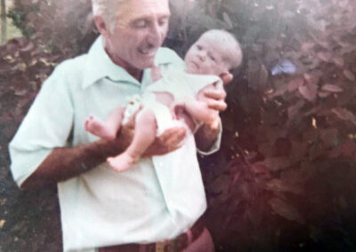 Holding his grandson.