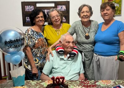 On his 107th birthday, with his four daughters.