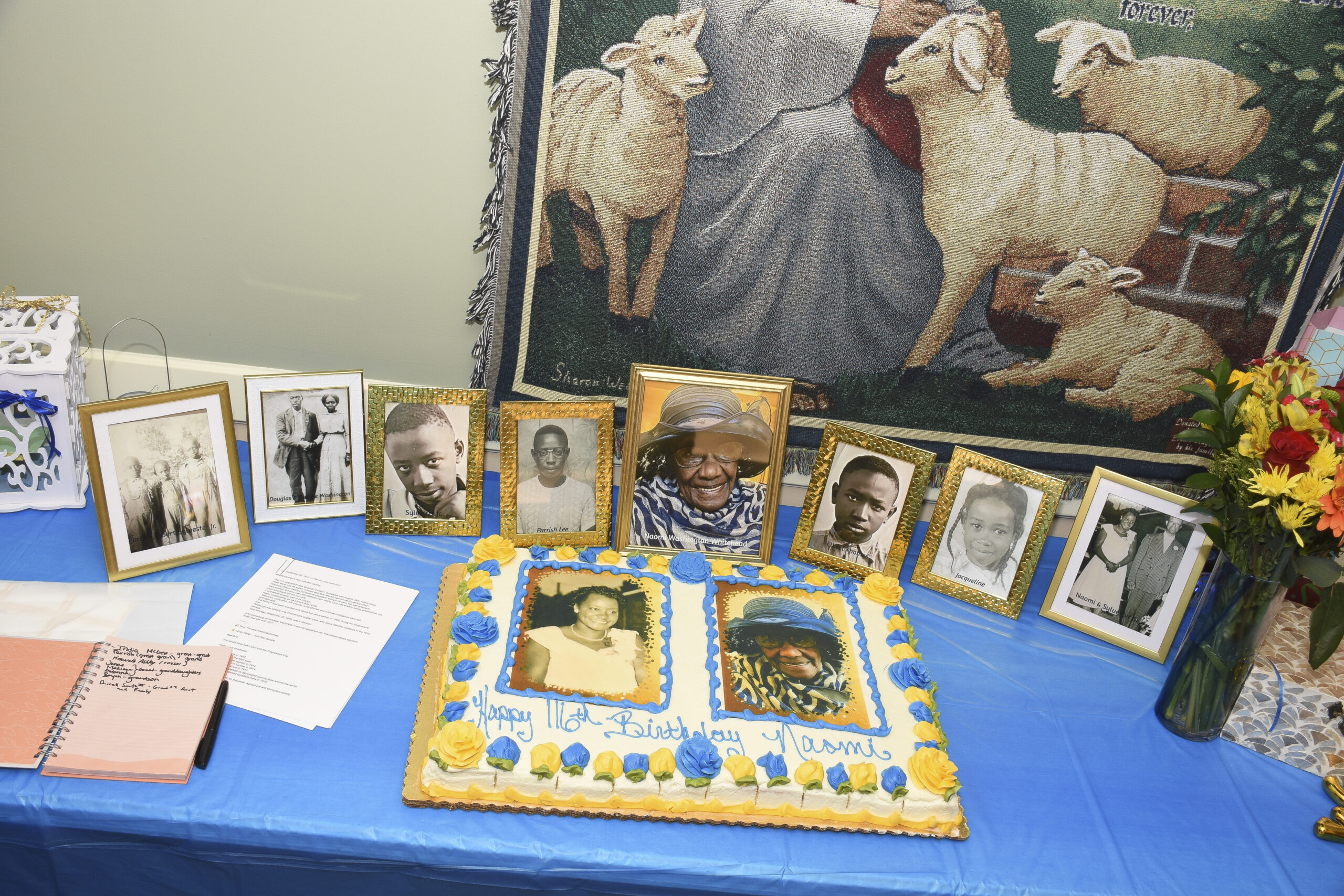 Photos and cake displayed for Naomi Whitehead's 116th birthday.